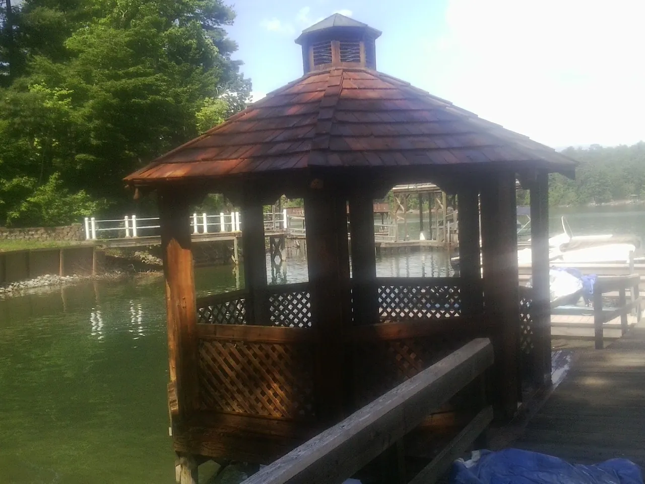 Cedar shake gazebo roof rebuilt on a lake dock in Francestown