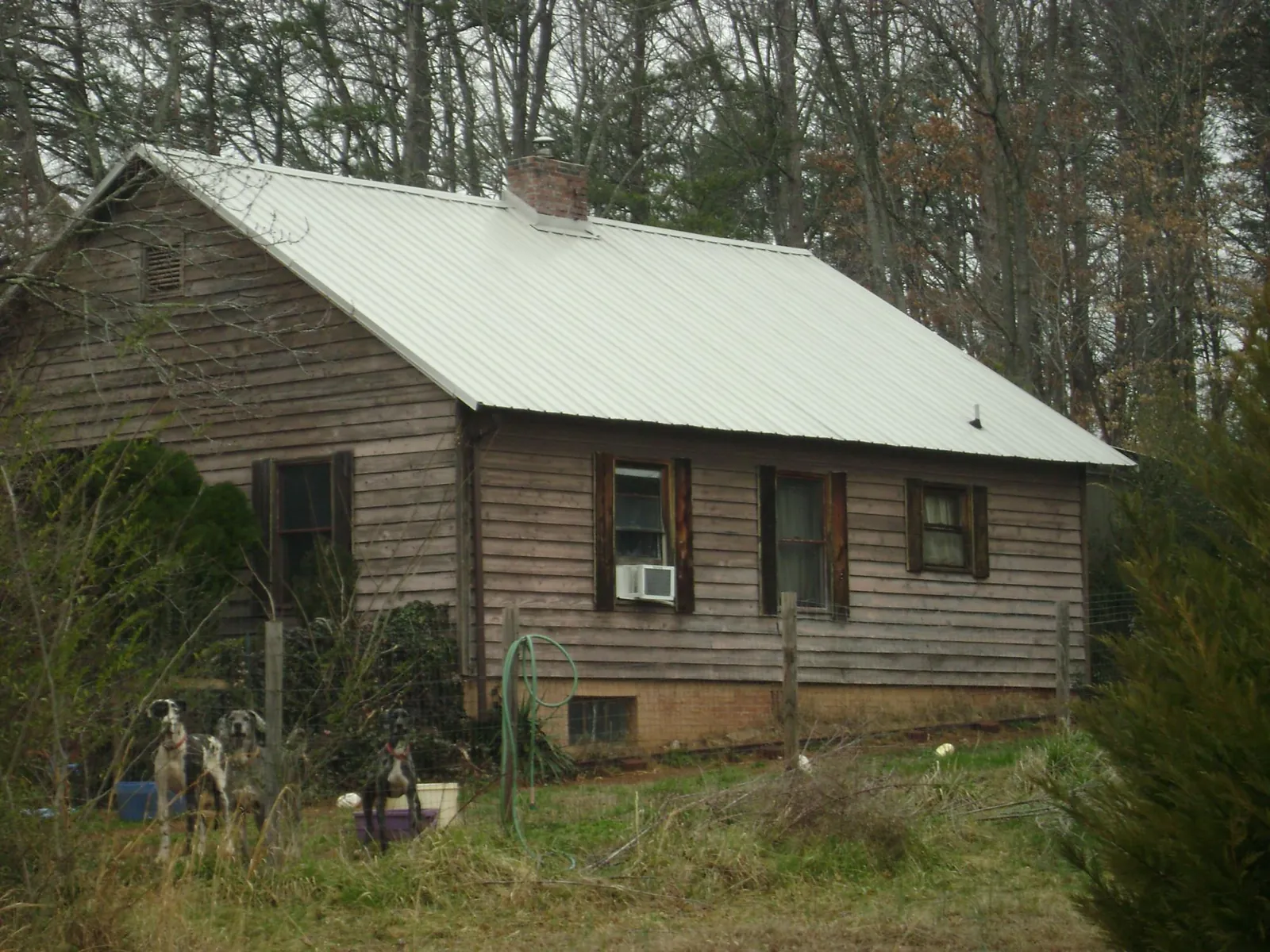 White metal roof on an old wood sided farmhouse, from a Metal Roof Installation job in Francestown